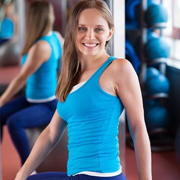 Pretty athlete Smiling pretty woman on the fitness ball